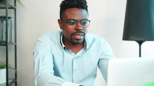 Man Has Video Call on Laptop in Office