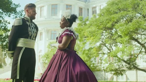 Aristocratic Couple in Period Costumes Talking Outdoors in Park