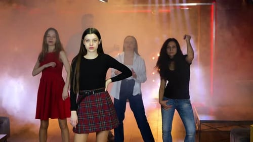 Women Dancing in a Nightclub with Fog