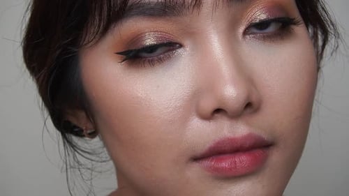 Woman Displays Glamorous Eye Makeup Close Up