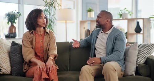 Couple Having a Serious Discussion on Couch