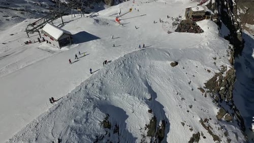 Aerial view of a ski slope with mountain enthusiasts in Saas Fee, Swiss alps station