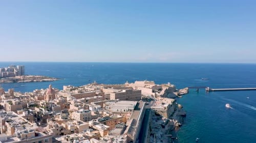 Drone flying above the city of La Valletta in Malta. flying backwards
