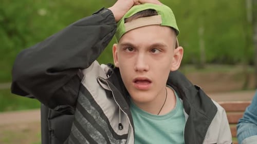 Teen Smiling Outdoors in Wheelchair on Sunny Day