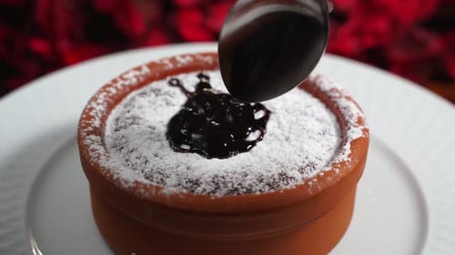 Chocolate Dessert in Earthenware Dish Being Scooped