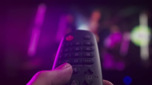 Frau mit Fernbedienung in der Hand, die Kanäle umschaltet, Smart-TV-Technologie, Bildschirm mit Internet-Videoinhalten, mit