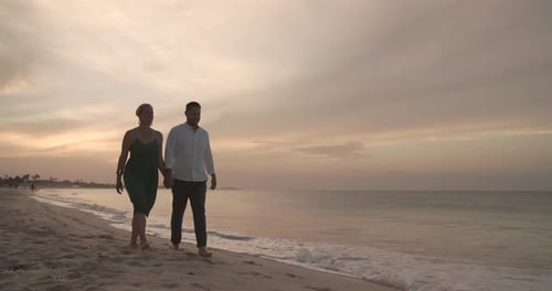 Caribbean honeymoon sunset walk on the beach for a happy couple in love