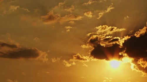 Golden Sky with Clouds and Sun