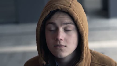 Sad, Pensive Young Teenager Riding Escalator Stairs in the City Adolescent