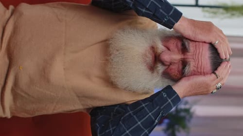 Older Man Rubbing Head in Vertical Video