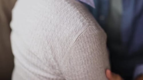 Senior Couple with Hand on Shoulder in Home Setting