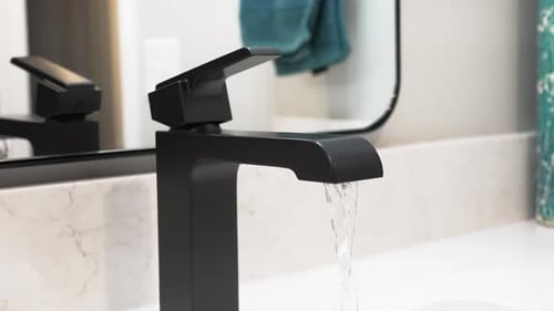Up close look at a new age faucet in a redesigned bathroom.