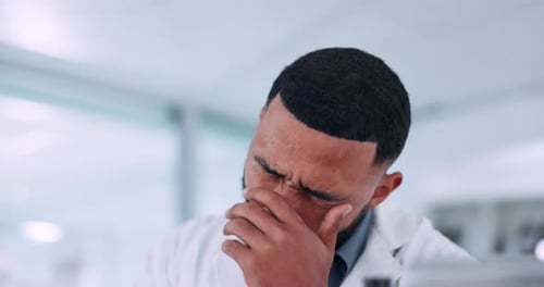 Male Scientist in Lab with Computer Looking Concerned