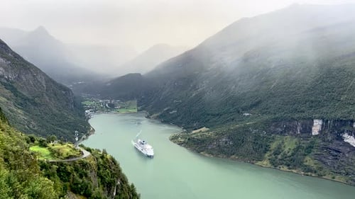A scene on a rainy day of a cruise crossing the Geiranger Fjord, Norway