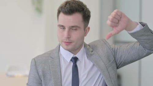 Portrait of Young Businessman showing Thumbs Down
