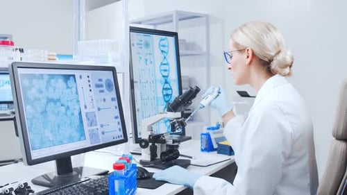 Scientist Using Microscope in Bright Research Laboratory