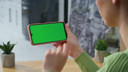 Woman Swiping Phone with Green Screen Background