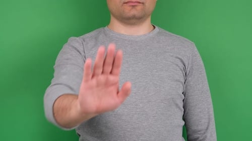 Adult Giving Stop Hand Gesture on Green Screen