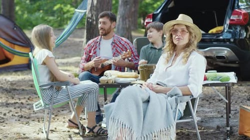 Family Relaxing and Camping in the Woods