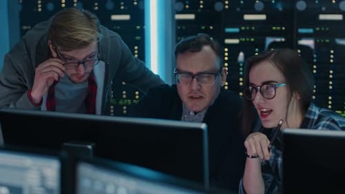 Three IT Engineers / Programmers Talking about Work, Using Computers. Technical Department with Dat