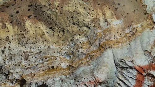 Bare rocks with numerous tiny shrubs. Flight over the geological formations in Arizona, USA.
