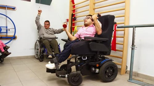 Men Doing Arm Exercises in Wheelchairs at Physical Therapy