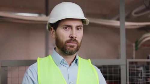 Confident Engineer with Safety Gear in Electrical Substation Technical Room