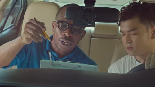 School Instructor Explaining Driving Test Evaluation to His Student
