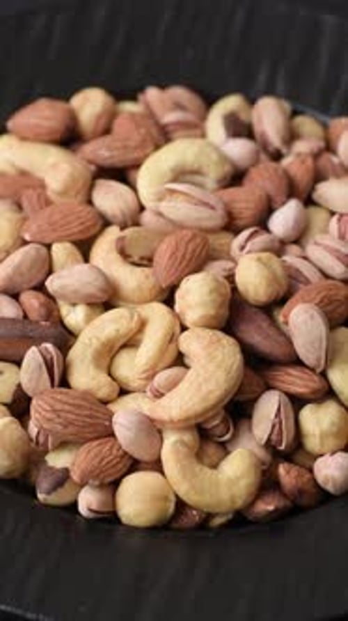 A mix of cashews, pistachios, almonds, macadamia and hazelnuts. Nuts as a food background