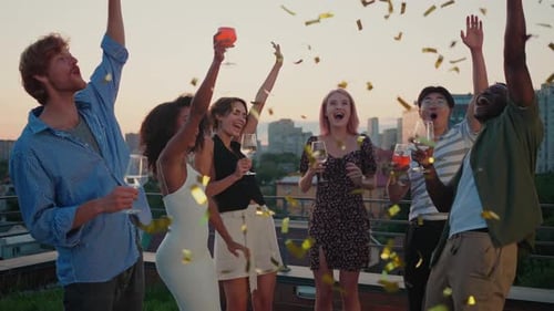 Young and Live Friends Having Cocktail Party with Confetti