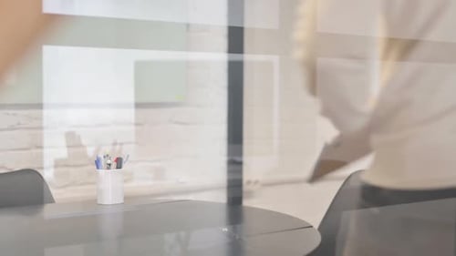 Man Opens Laptop to Work in Modern Office