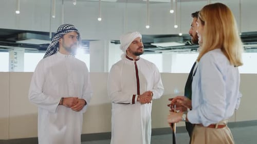 Cooperative Four Business People Negotiating in Corporate Office Center Arabic Investors in Kandura