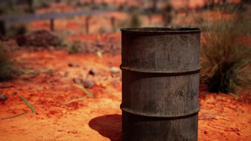 Old Empty Rusted Barrel on Sand