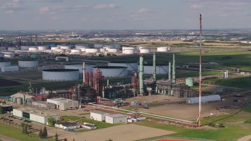 Expansive Aerial View of Industrial Refinery with Vast Storage Tanks