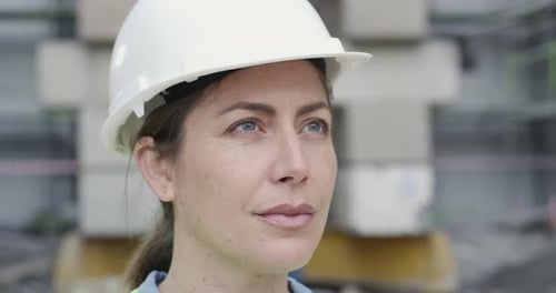 A young woman inspecting a construction site