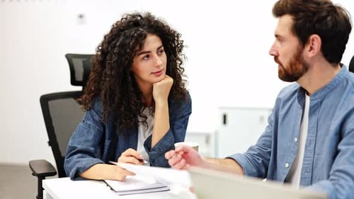 Focused Business Meeting Professionals Collaborate on Project Strategy in Modern Office