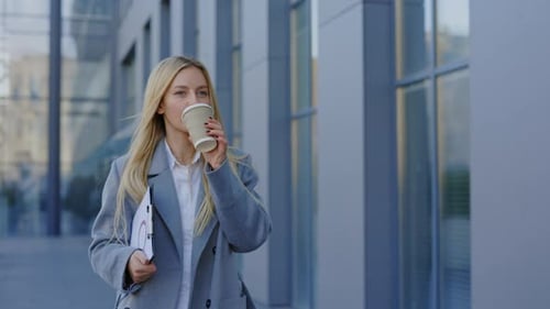 Young Business Woman Going to Office While Coffee Break Holding Charts