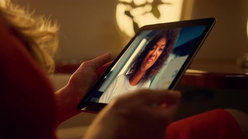 Freelancer Hands Holding Tablet Having Video Call with Office Colleague Close Up