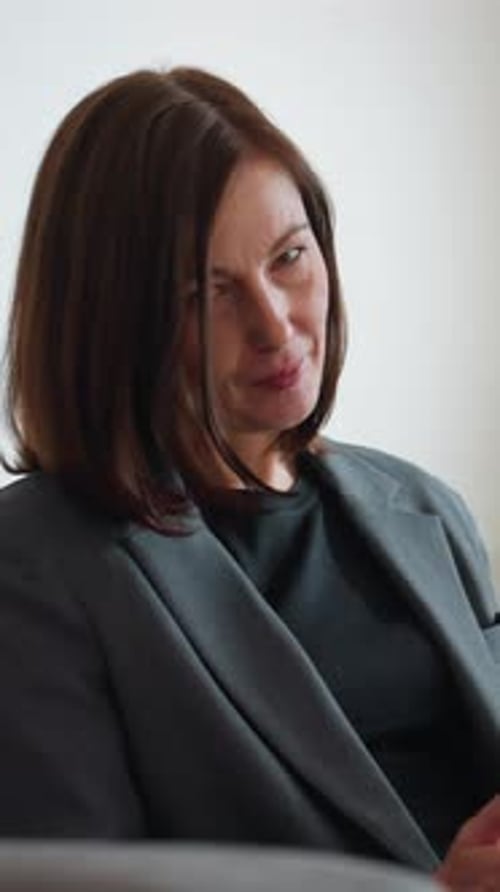 Businesswoman Browsing Tablet in Modern Office Lounge with Indoor Plants