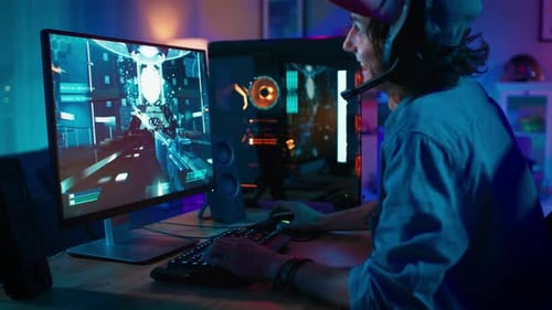 Man plays video game with headset at desk