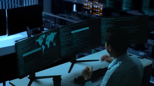 Side View Of Happy Asian Man Celebrating While Write Code With Multiple Computer Screens In office