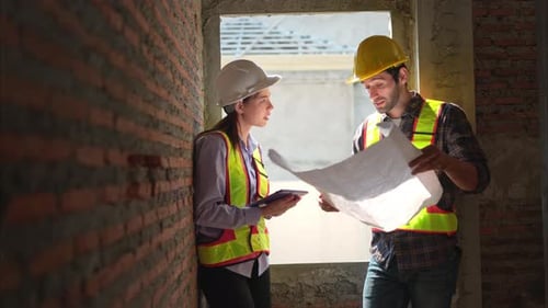 Architects and engineers work together to assess the residential home construction site's progress