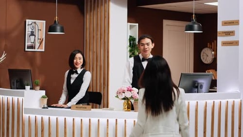 Front Desk Team Staff Welcoming Hotel Guest at Reception