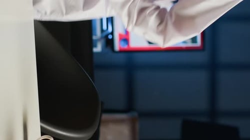 Man in Traditional Headwear Works at Laptop