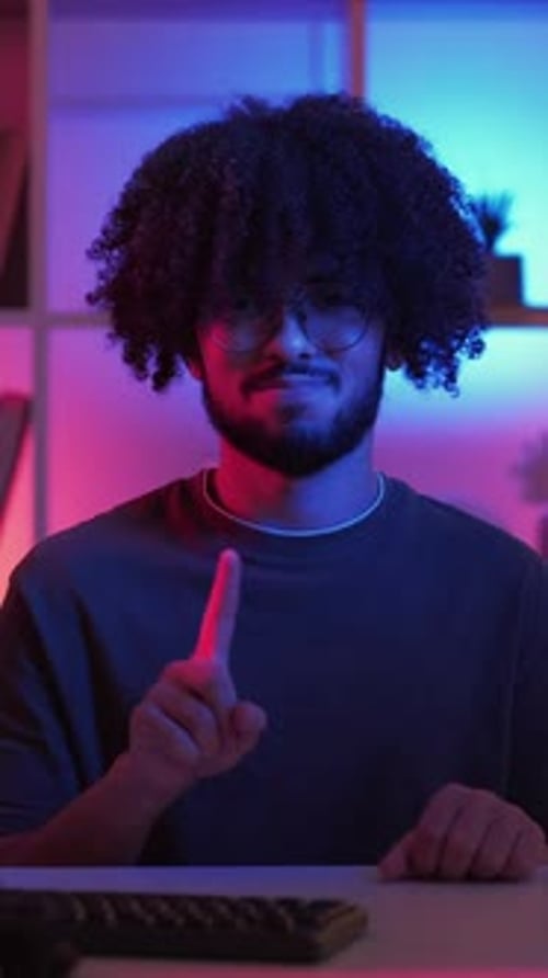 Stylish Man Raising Finger in Dark Lit Room