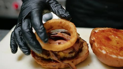 Juicy Burger Being Assembled in a Restaurant Kitchen
