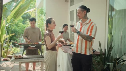 Group of People Toasting with Wine Having Grill Party