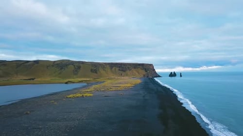 Aerial Drone View Footage Black Sand Beach and It's Rock Formations Reynisfjara, Vik Iceland