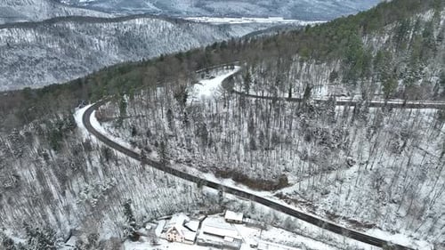 Aerial view of winding road in the forest, France.