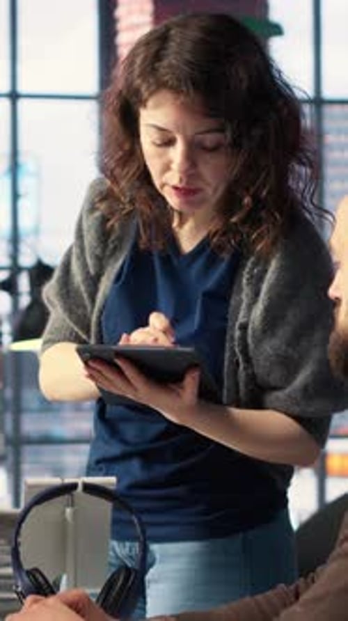 Vertical Video Man and Woman Collaborate on Content Creation for the Media Industry